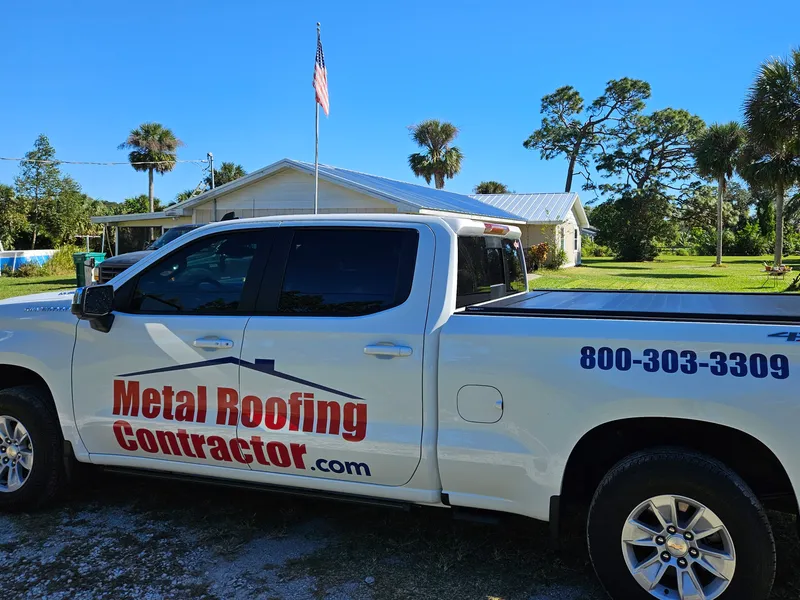 Metal Roofing Contractor truck with company logo and phone number